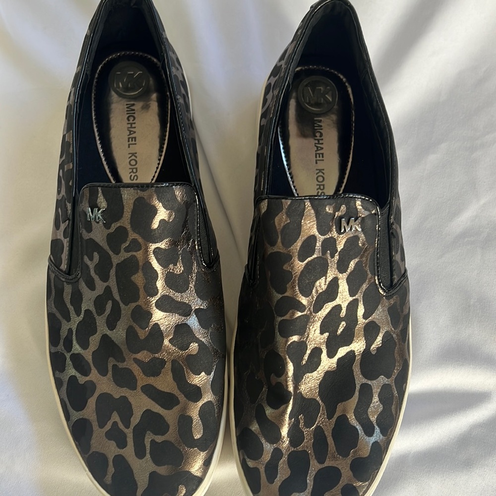 Men’s size 11 Michael Kors cheetah print black with a silver is bronze color